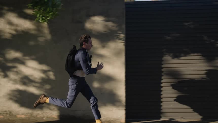 A man running down a street in slow motion