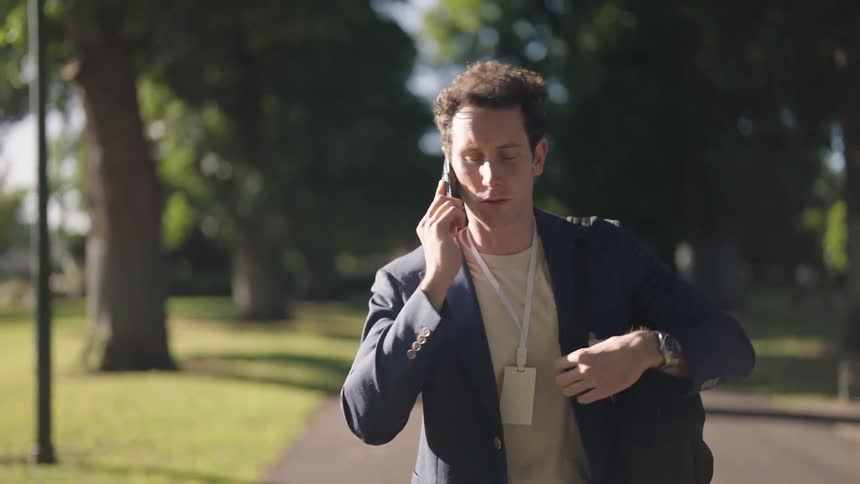 A man walks while talking on his cellphone