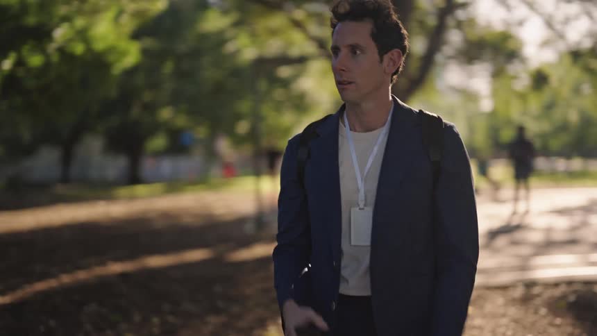 A man checking his phone and running