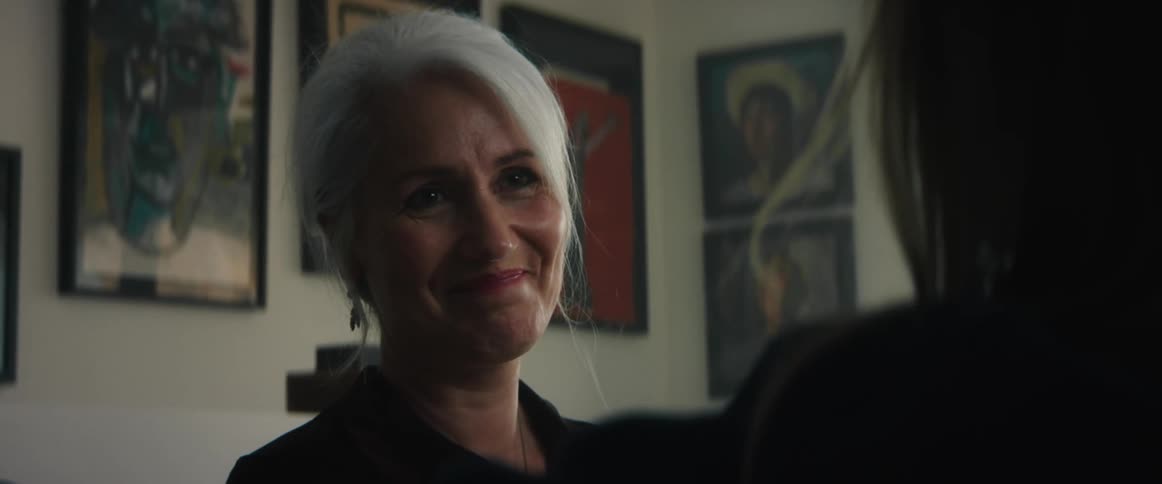 Two women talking to each other in a room