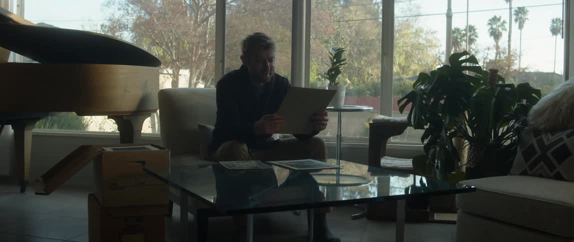 A man is looking at a photo at home