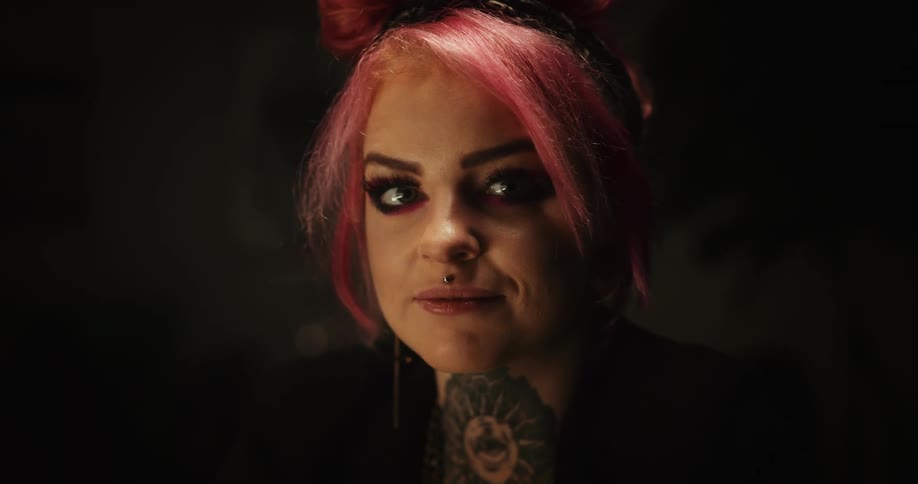 Close up of the face of a tattoo artist drawing on paper