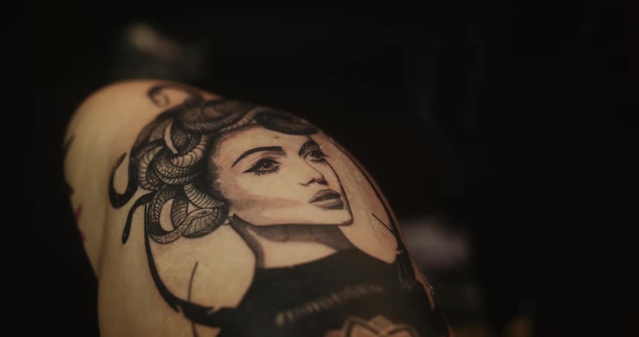 Tattoo artist cleans the skin of a customer after a tattooing session