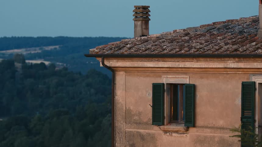 Chimney on the tiled roof of an european house in the countryside
