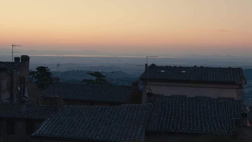 Tiled roof of european houses on a small town in the countryside at evening