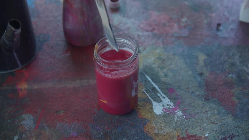 A person is mixing paint and water together