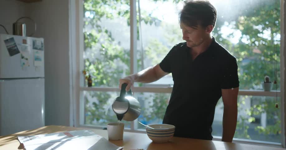 A man pours coffee into a mug