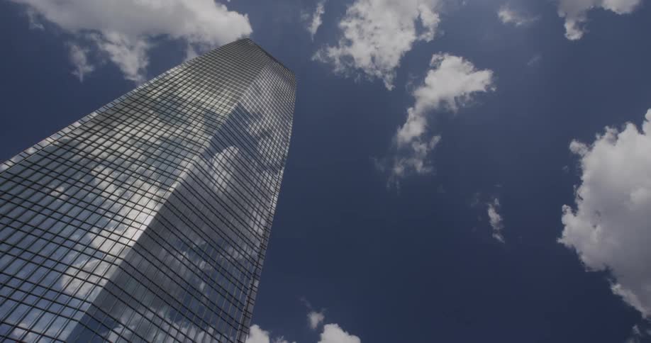 Clouds reflect in the glass of a skyscraper