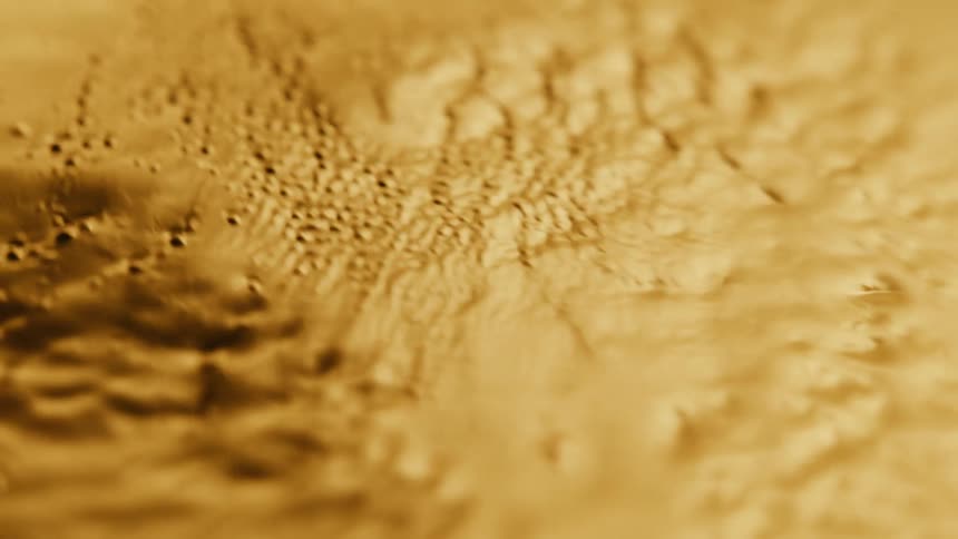 Close up of abstract thick yellow liquid moving