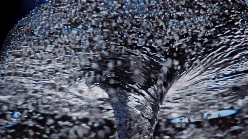 Liquid swirls in a cyclone with bubbles rising