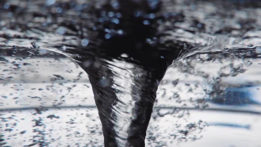 Underwater close up of a twisting water vortex