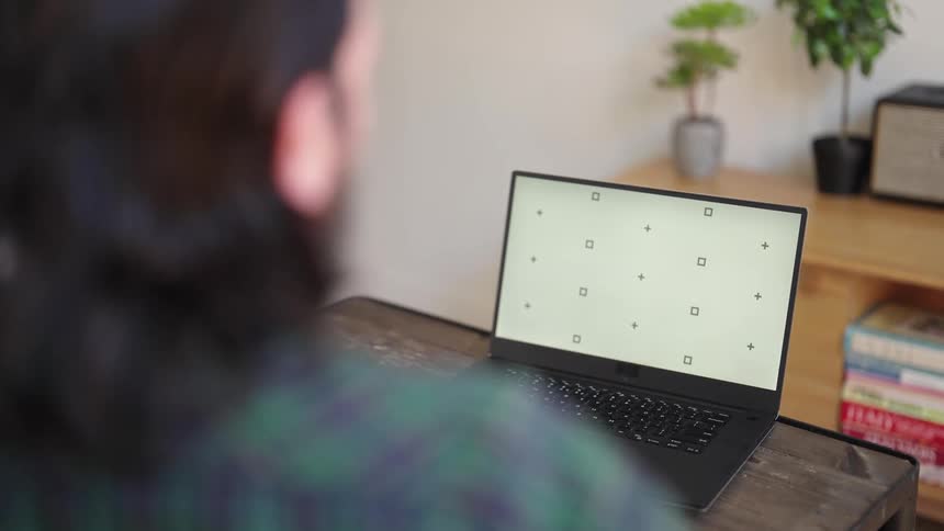 A man using a laptop in a room