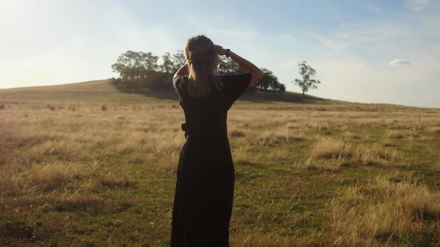A woman walking through a field