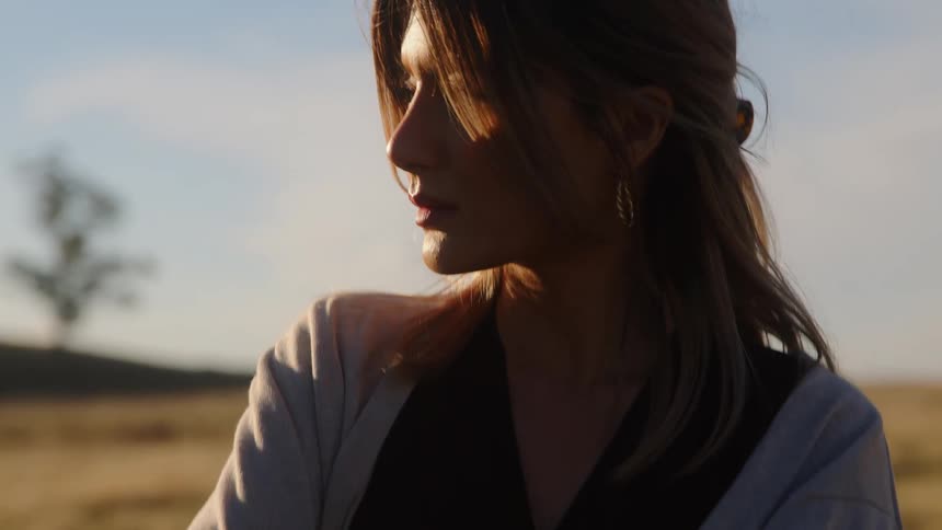 A woman is waiting on the field