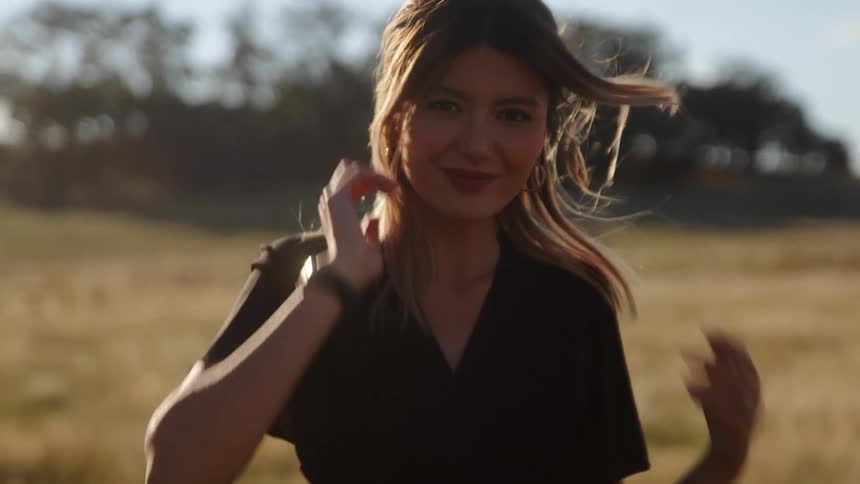 Young woman is walking around the forest area in the day time