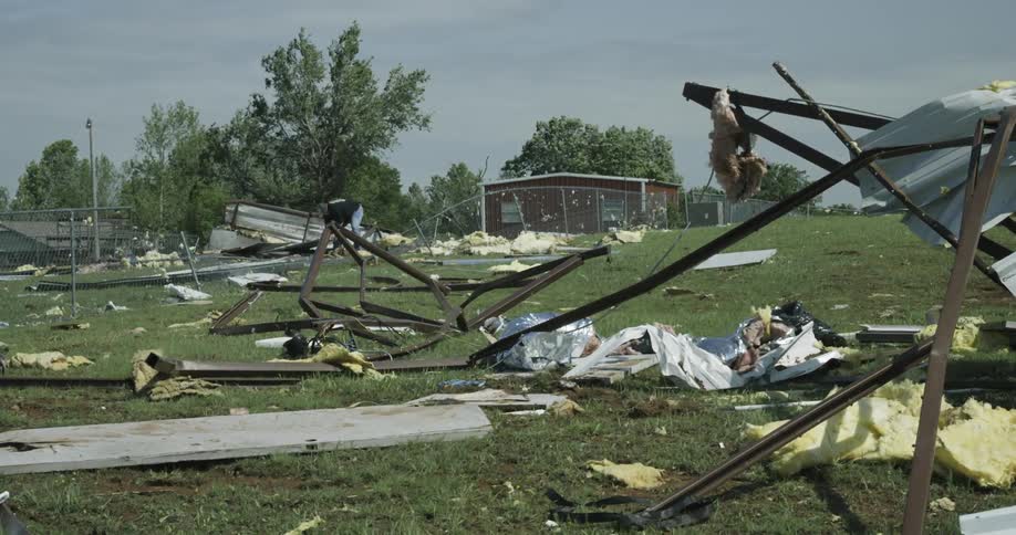 A man searching through storm debris