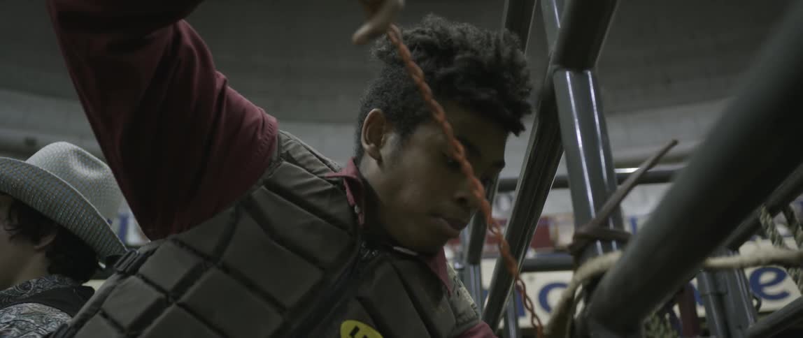 A man ties a chain around a pole