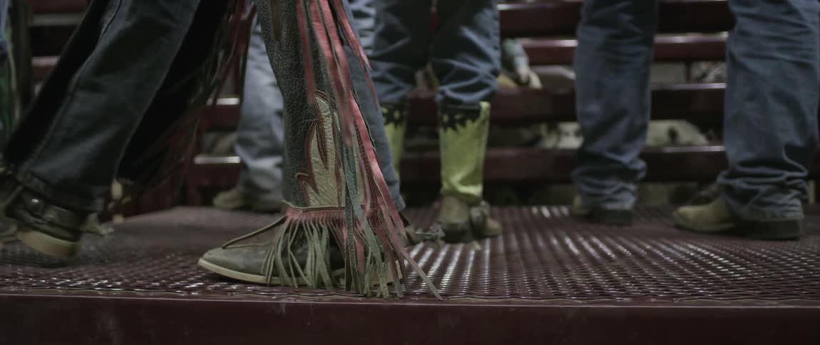 A man with spur heeled boots walks past