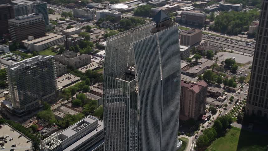 Aerial orbit footage of the 1180 Peachtree building and Midtown Atlanta skyscrapers during the summer