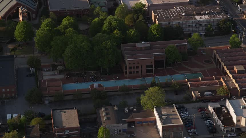 Aerial footage of the Martin Luther King Jr Memorial fountain with clear skies and surrounding landmarks in Atlanta GA during the day