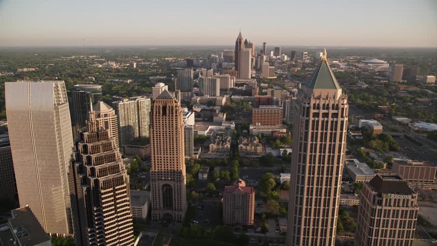 A stunning aerial footage of Midtown Atlanta orbiting Promenade II and revealing a cluster of tall skyscrapers during the day