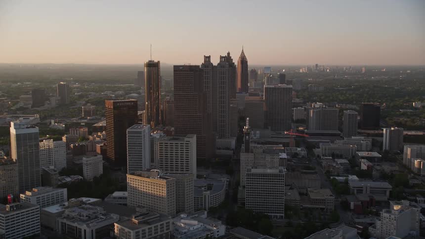 A breathtaking aerial view of downtown Atlantas skyscrapers and high-rises standing tall over the city on a hazy day