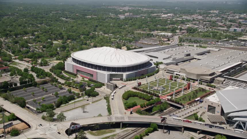 Approaching the Georgia Dome in downtown Atlanta an aerial view captures the citys skyline and the bustling atmosphere of the football stadium