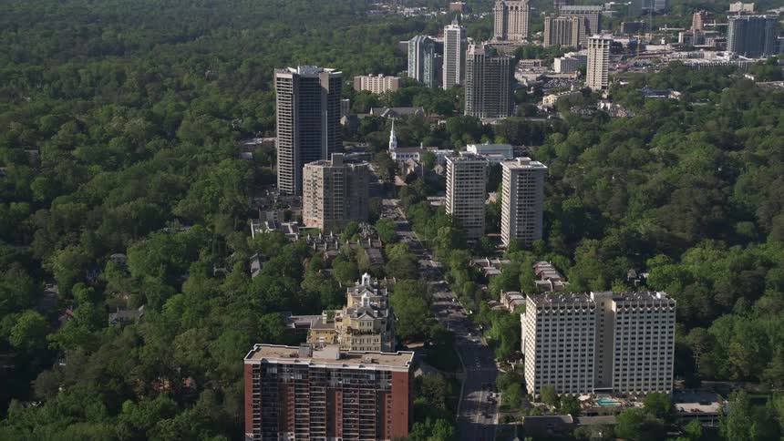 Aerial view of Peachtree Road passing through Buckhead Georgias condominium and tree-filled areas