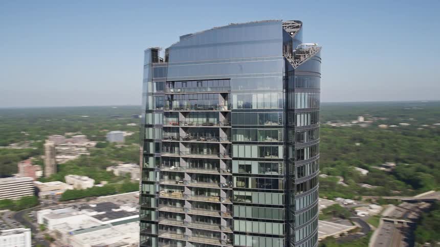 A stunning aerial view of the top of 3344 Peachtree skyscraper in Buckhead Georgia on a sunny day