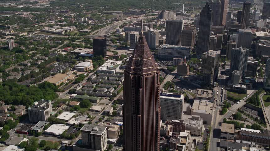 An aerial view circling around the Bank of America Plaza in Midtown Atlanta during a sunny day