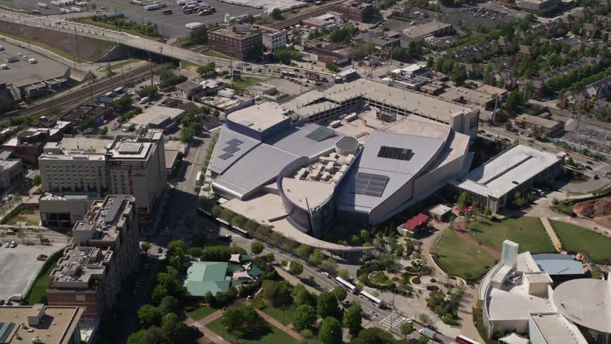 Approaching the Georgia Aquarium from an aerial perspective during a sunny day in downtown Atlanta