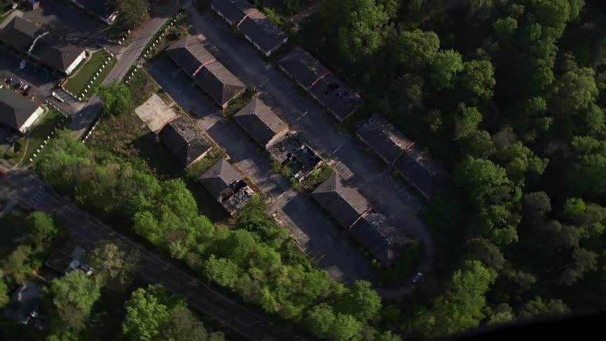 A stunning aerial view of deserted rundown buildings surrounded by trees in Atlanta