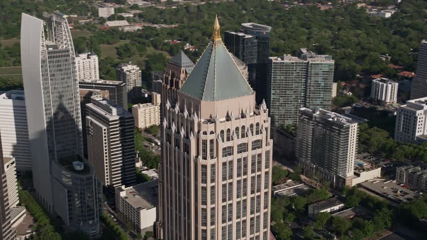 Approaching Midtown Atlanta aerial footage captures the impressive One Atlantic Center tower and surrounding modern skyscrapers on a sunny day