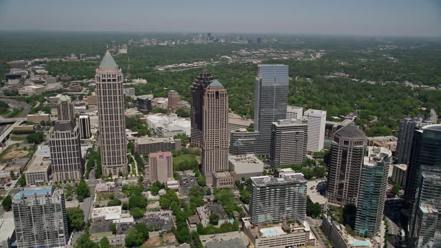 Flying over Midtown Atlanta skyscrapers during a sunny day in Georgia