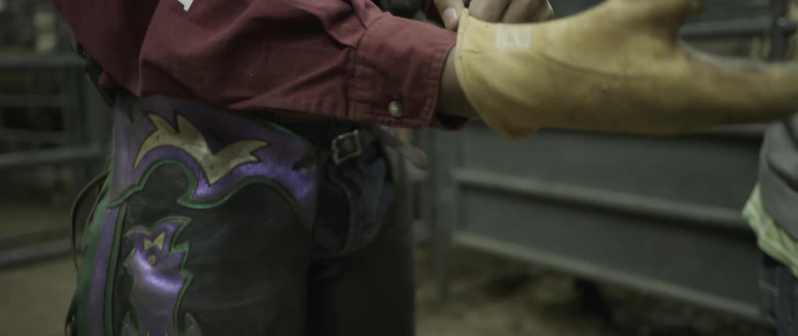 A man puts on a yellow glove