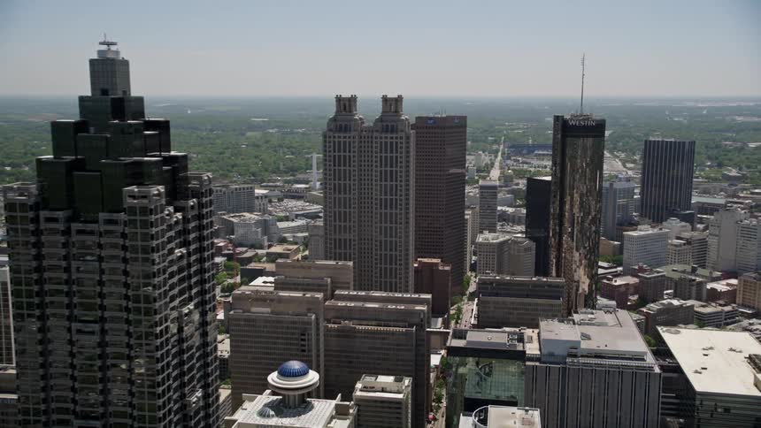 An aerial view of the SunTrust Plaza and other skyscrapers along with the Westin Peachtree Plaza Hotel in downtown Atlanta on a sunny day