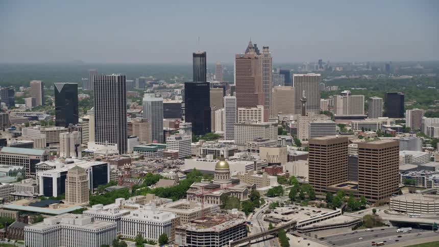 Approaching downtown Atlantas towering skyscrapers and Georgia State Capitol on a sunny day