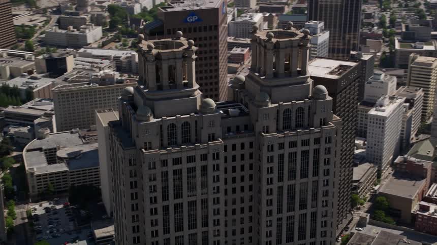 Aerial view of 191 Peachtree Tower orbiting to reveal Westin Peachtree Plaza and Downtown Atlanta in the daytime