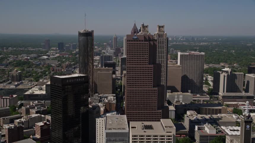 Aerial footage of downtown Atlanta Georgia showcasing skyscrapers and high-rise buildings including the Westin Peachtree Plaza Hotel and the Georgia Pacific Tower