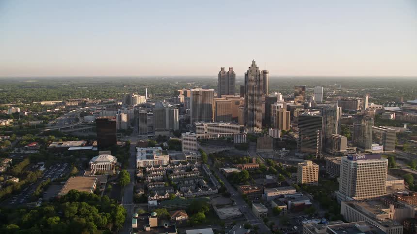 Approaching Downtown Atlantas skyline this aerial stock footage captures the towering skyscrapers of Bank of America Plaza and SunTrust Plaza amidst hazy springtime skies
