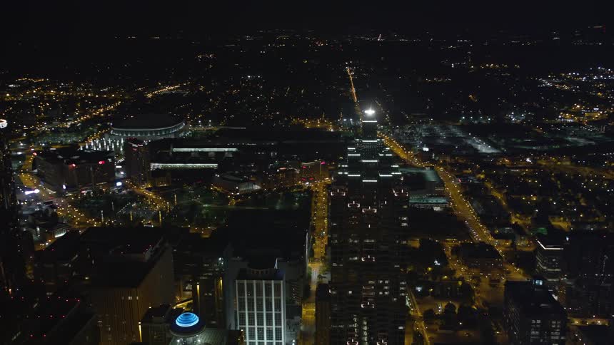 A stunning aerial shot of SunTrust Plaza orbiting the nearby skyscrapers of downtown Atlanta revealing the city at night