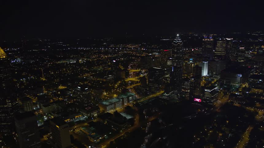 A stunning night aerial view of Midtown Atlanta Georgia with clear skies skyscrapers and all the buildings lit up beautifully