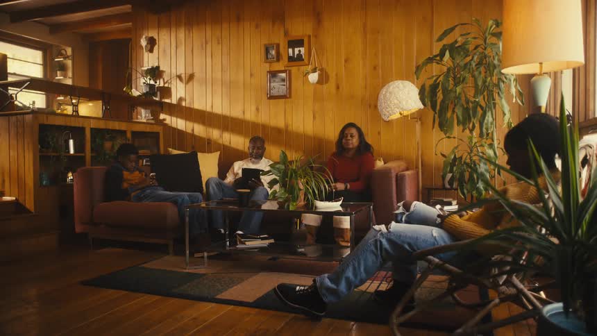 A family sitting around in a room together