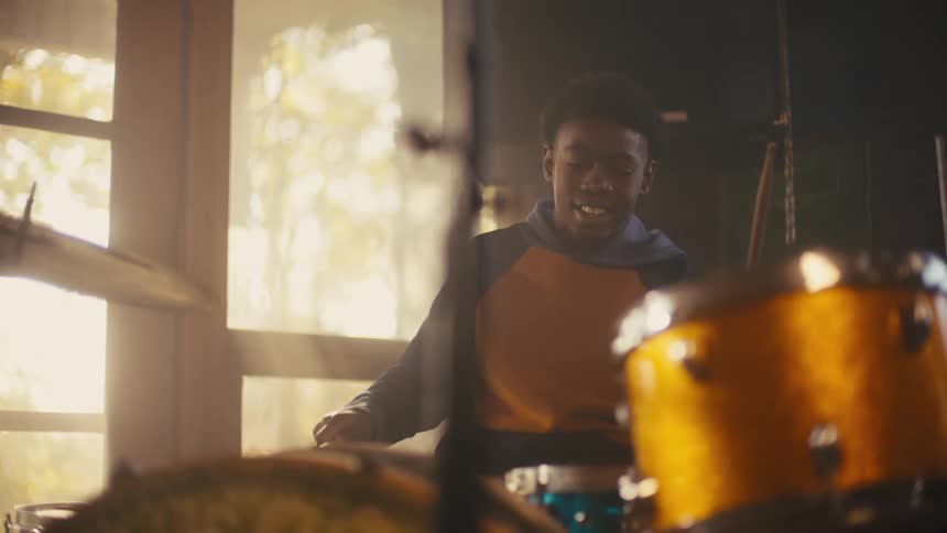 A boy is playing the drums