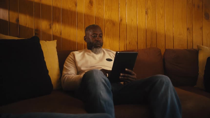 A family sitting around using electronic devices
