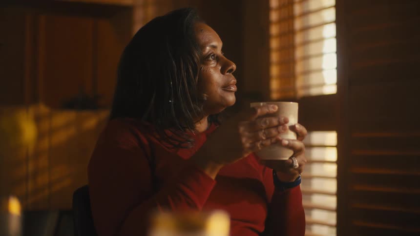A woman drinking from a cup