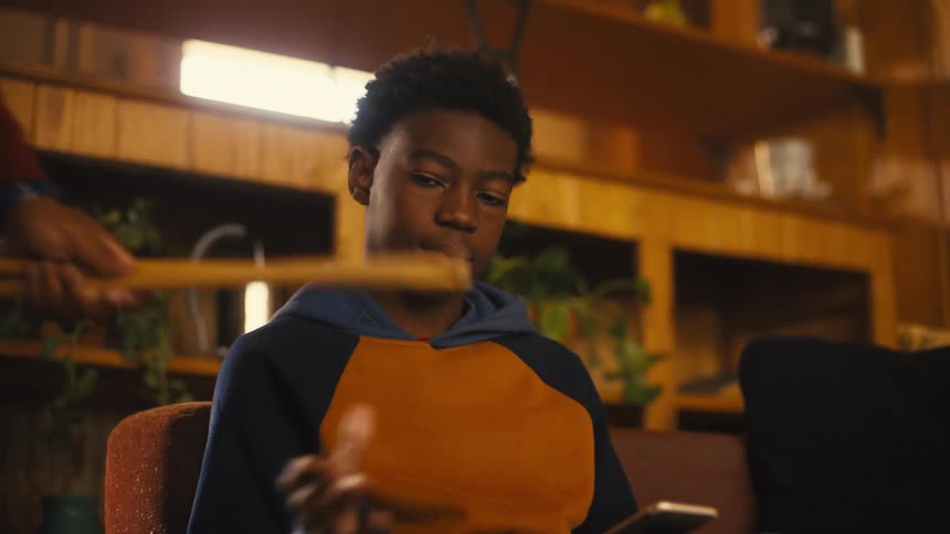A child is handing drumsticks