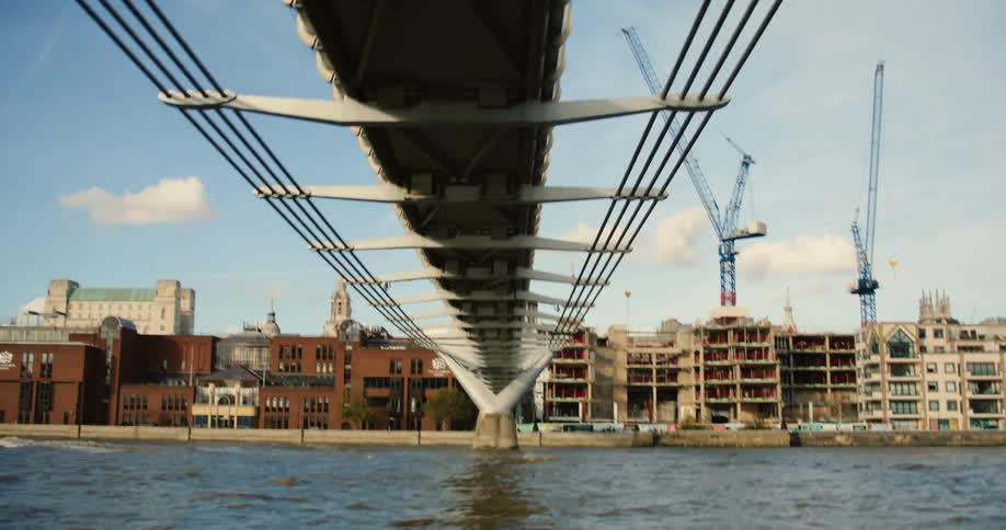 View from under Millennium Bridge and St. Paul's Cathedral from boat on River Thames