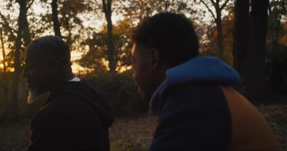 A father and son talk in the yard