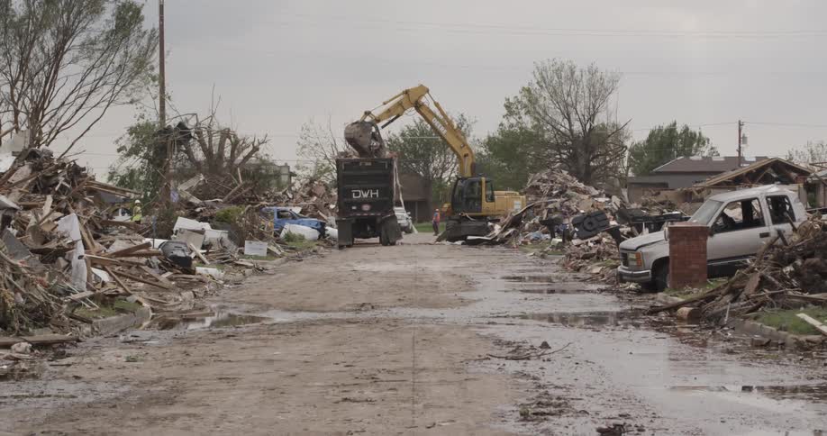 A work crew cleans up storm debris